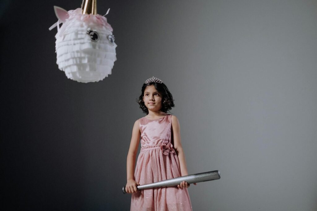 Woman in Pink Sleeveless Dress Holding White and Pink Floral Hand Fan