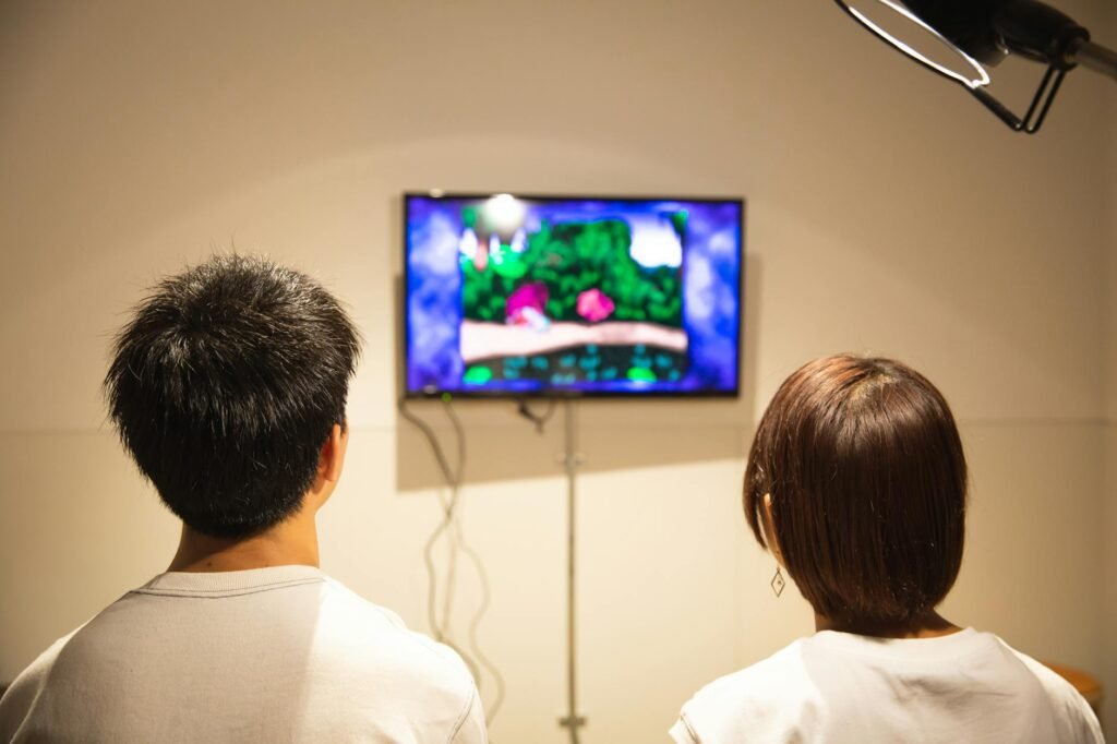 Unrecognizable young couple playing video game at home