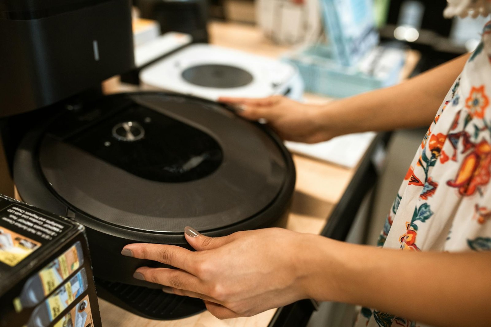 Person Holding A Robotic Vacuum Cleaner