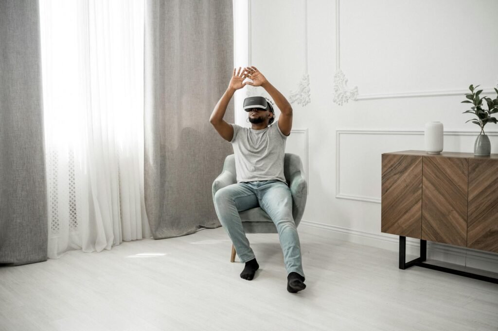 Man in Gray Crew Neck T-shirt Wearing White and Black Vr Goggles