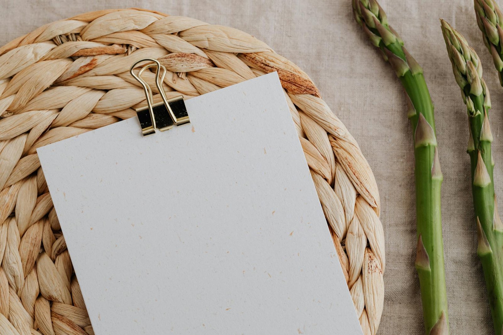 Asparagus Near Brown Woven Mat on Brown Table