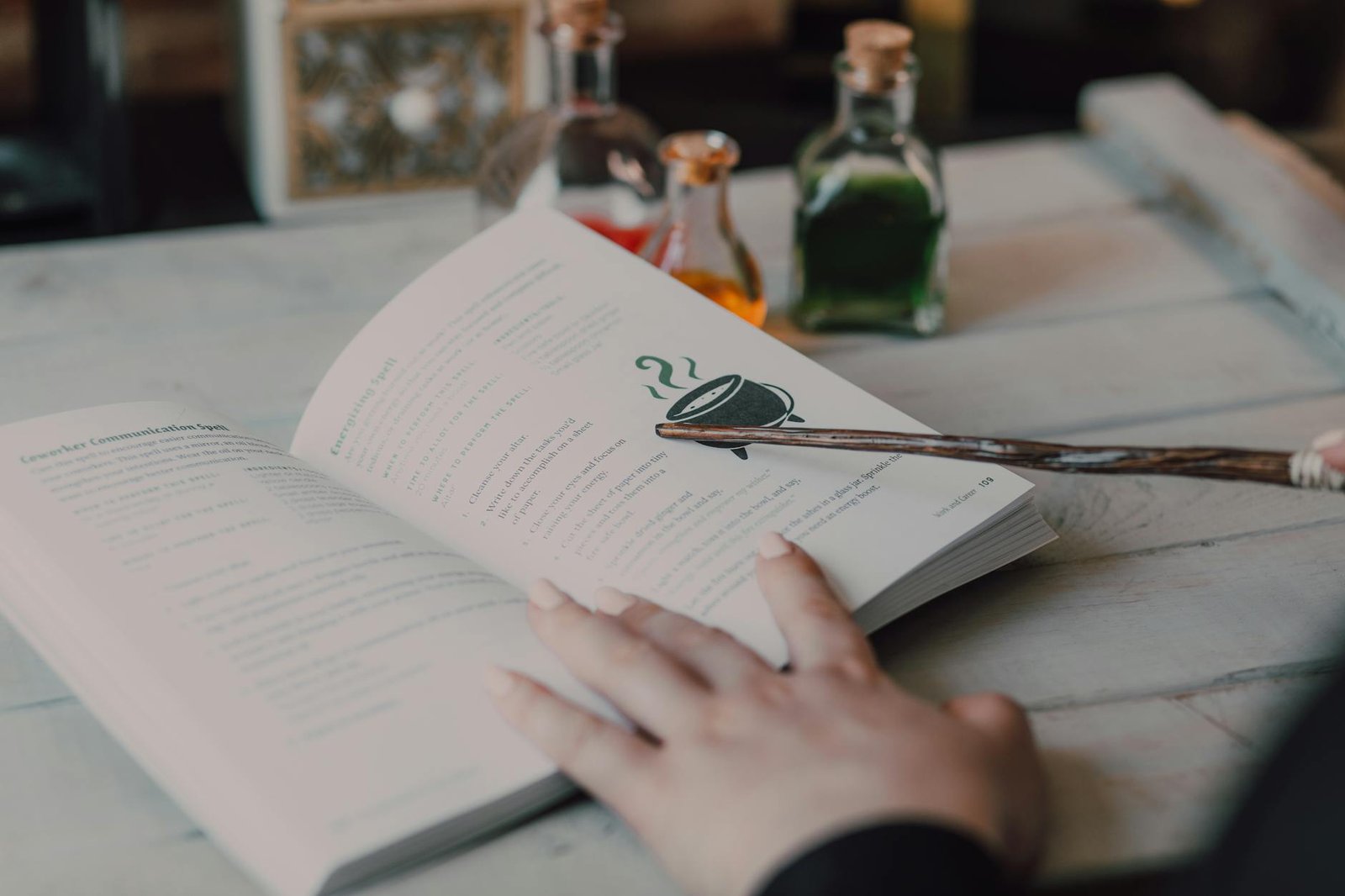 image Close-Up Shot of a Person Holding a Wand a Book