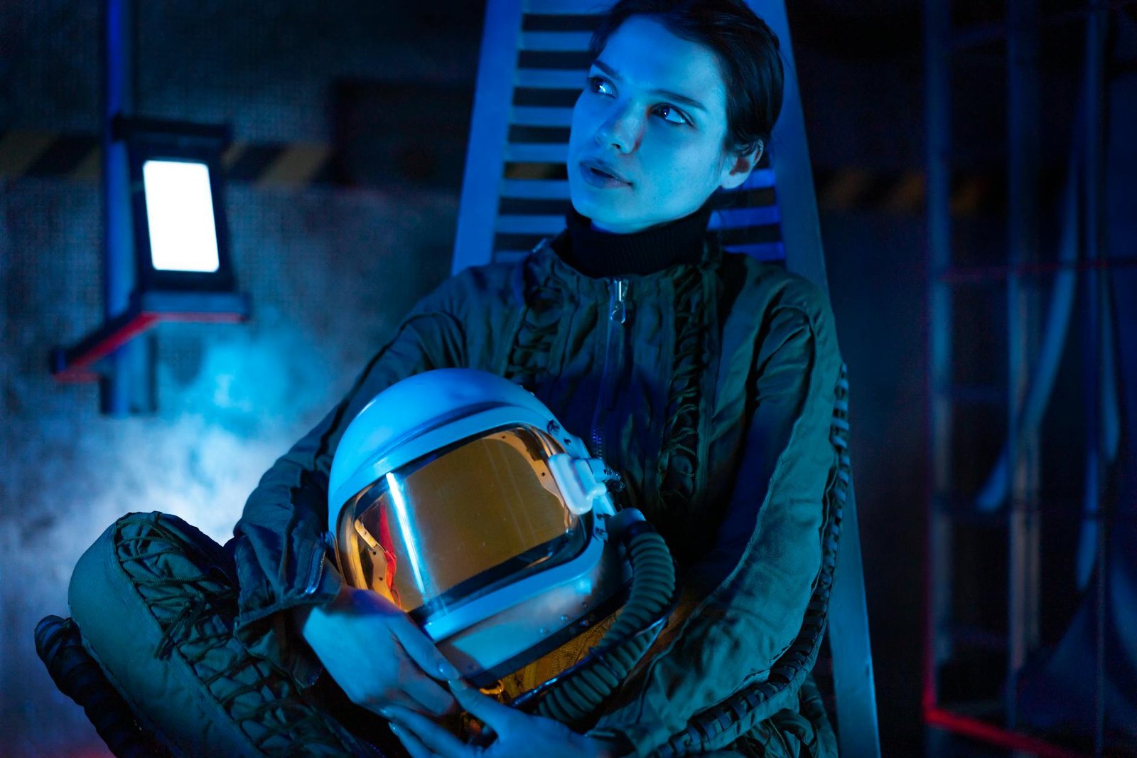 Woman In A Spacesuit Holding A Helmet