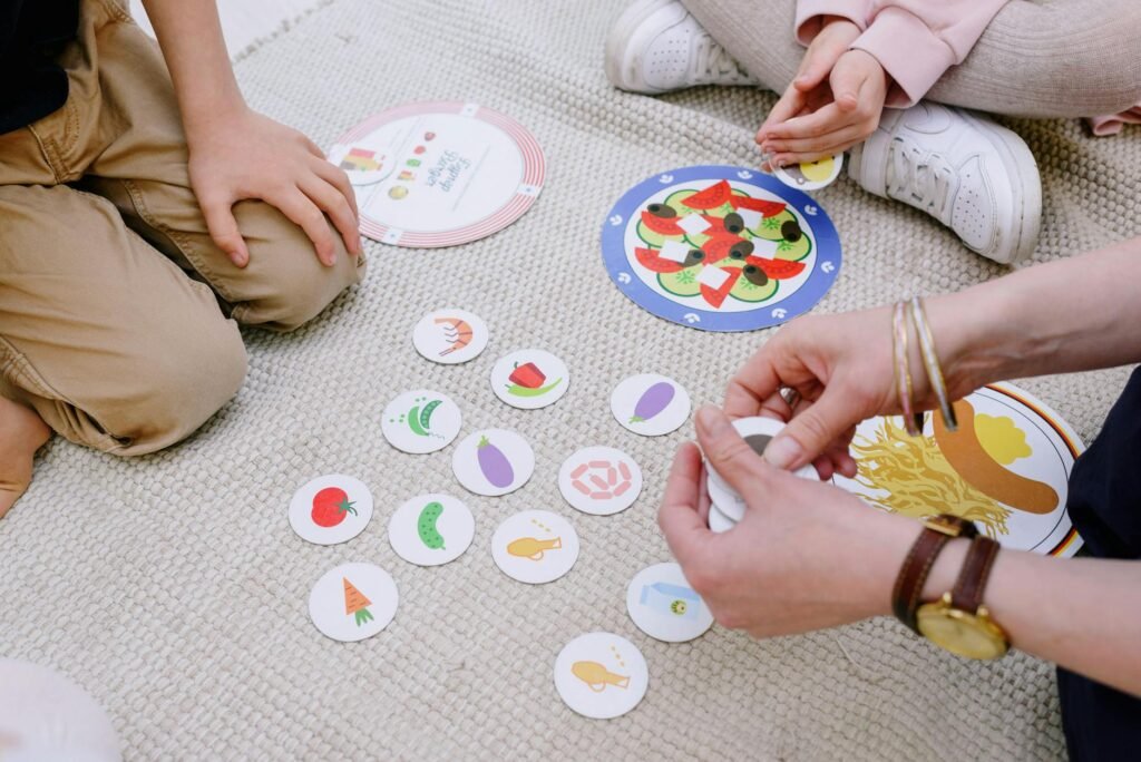 Children playing an educational card game inside, focusing on activity and learning.