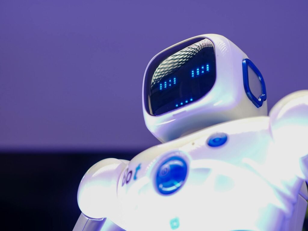 A modern humanoid robot with digital face and luminescent screen, symbolizing innovation in technology.