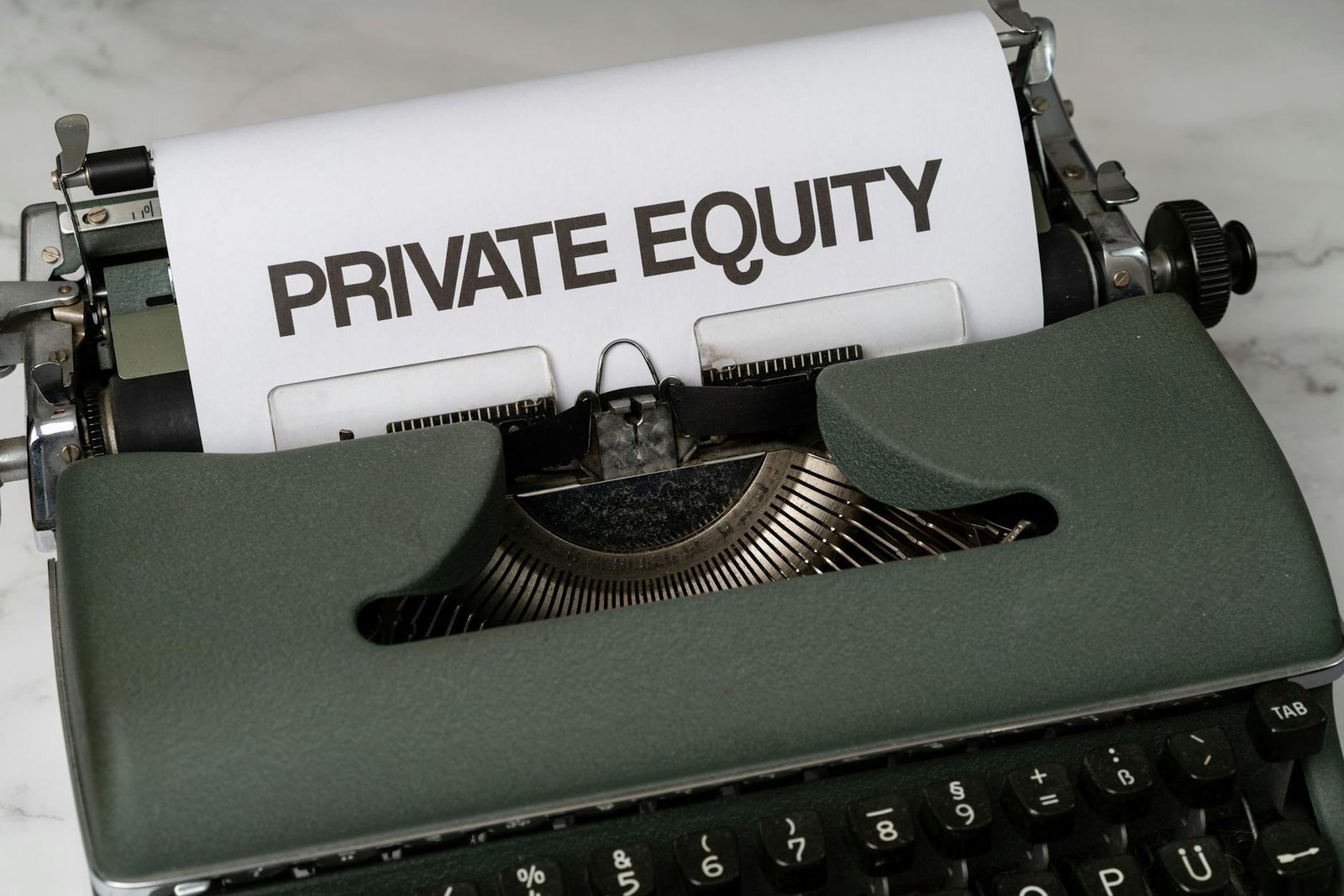 Close-up of vintage typewriter with 'PRIVATE EQUITY' on paper, business concept.