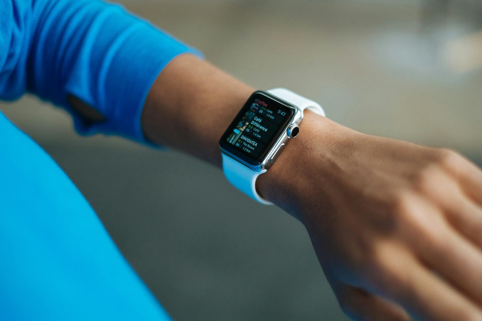 Focus on a smartwatch worn on an adult's wrist, showcasing its digital display.